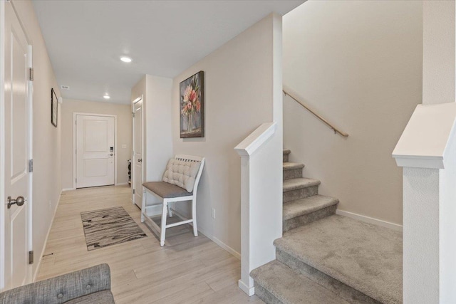 interior space with light wood-style floors, stairs, baseboards, and recessed lighting