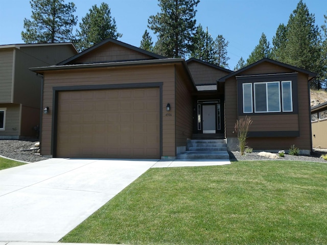 view of front of home featuring an attached garage, a front lawn, and concrete driveway