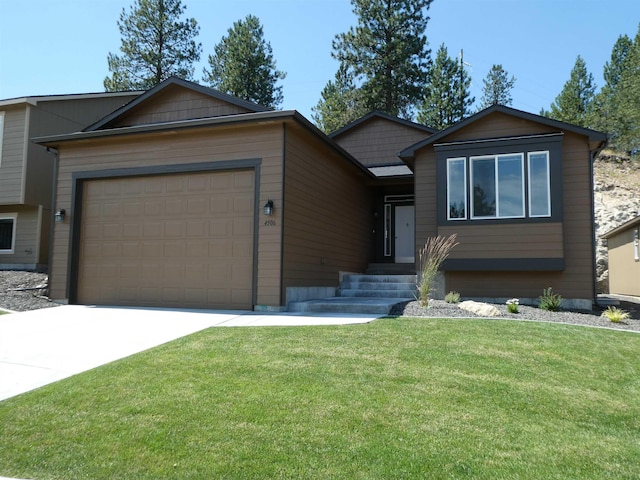 view of front of home with driveway, a front lawn, and an attached garage