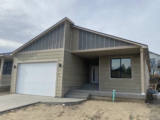 view of front of home with board and batten siding, concrete driveway, and a garage