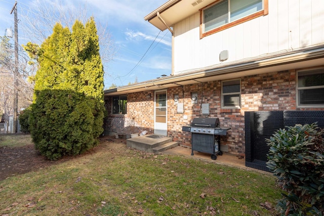 back of property with visible vents and a lawn