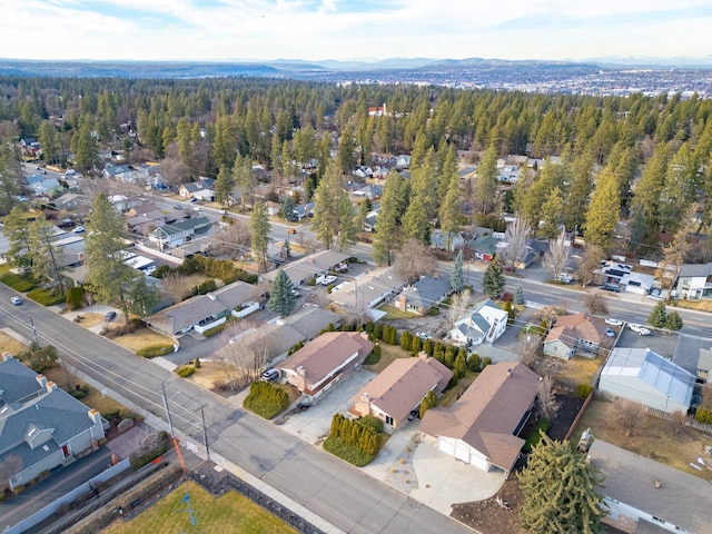 drone / aerial view featuring a residential view and a view of trees