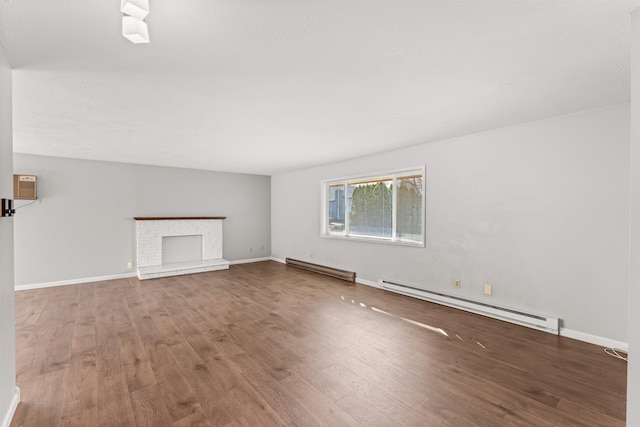 unfurnished living room with baseboards, a fireplace, baseboard heating, and wood finished floors