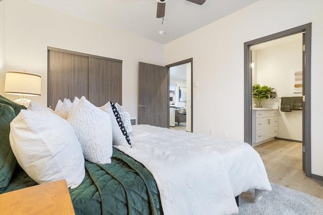 bedroom with light wood-type flooring, connected bathroom, and a ceiling fan