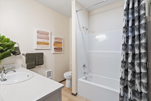 full bathroom featuring wood finished floors, vanity, visible vents, and shower / bathtub combination with curtain