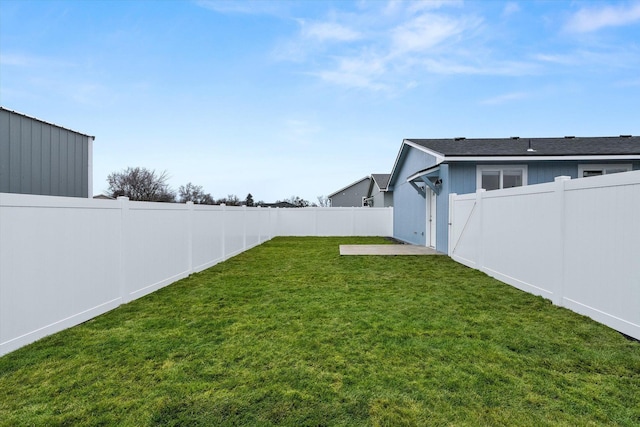 view of yard with a fenced backyard