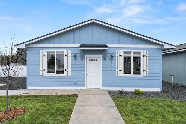 bungalow-style home with a front lawn