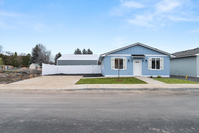 view of front facade with board and batten siding and fence