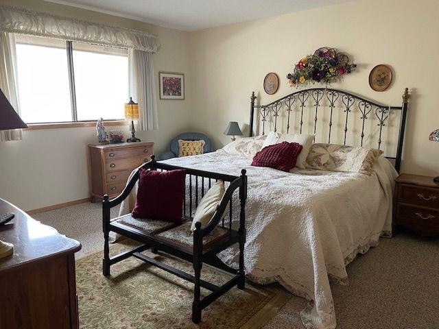 carpeted bedroom with baseboards