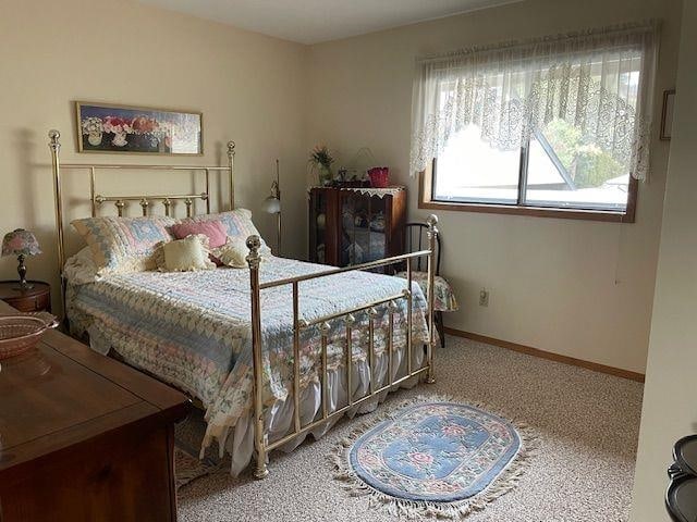 bedroom with carpet floors and baseboards