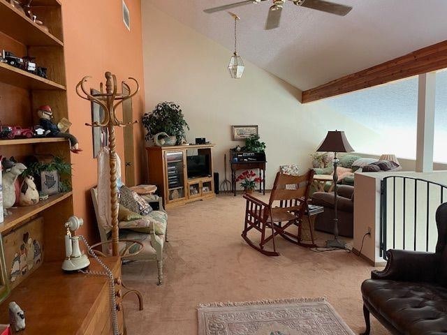 living room featuring beam ceiling, visible vents, light colored carpet, a ceiling fan, and high vaulted ceiling