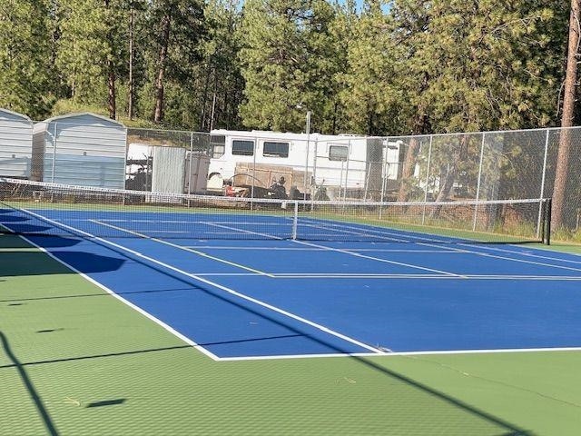 view of sport court with fence