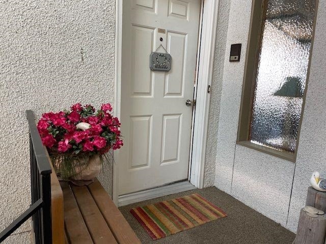 doorway to property with stucco siding