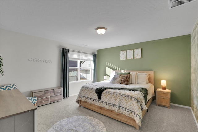 bedroom featuring carpet floors, visible vents, and baseboards