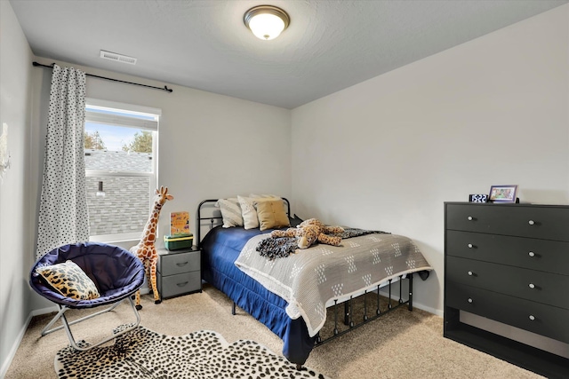 bedroom featuring baseboards, visible vents, and carpet flooring