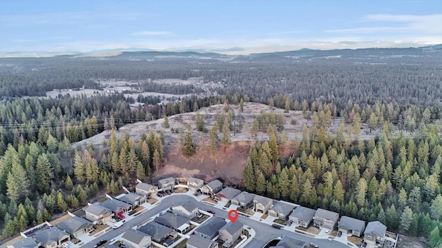 birds eye view of property with a mountain view and a view of trees