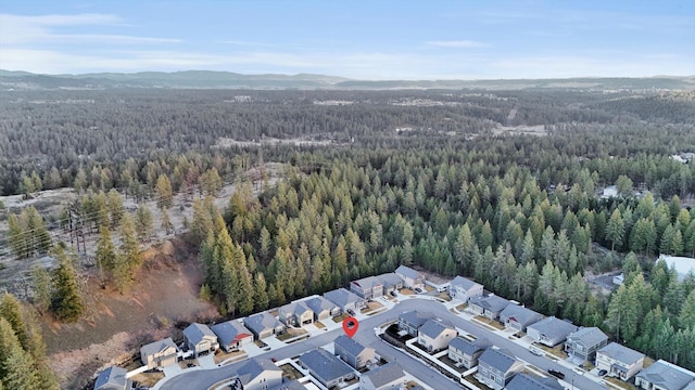 aerial view with a forest view, a residential view, and a mountain view