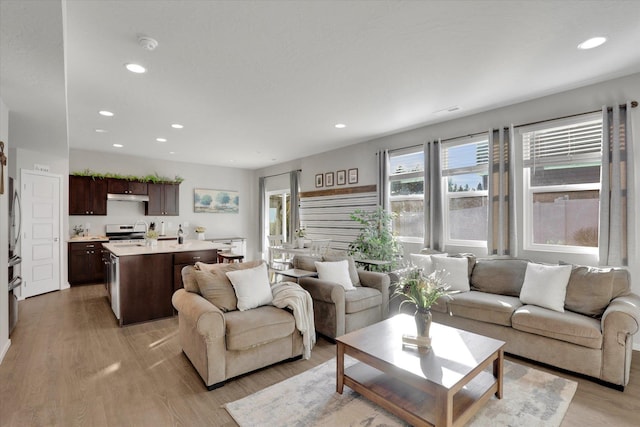 living area with recessed lighting, visible vents, and light wood-style flooring