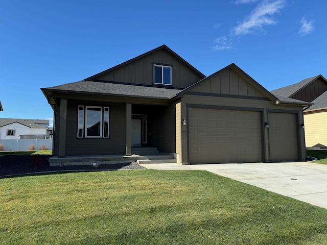 view of front facade with board and batten siding, a front lawn, driveway, and a garage