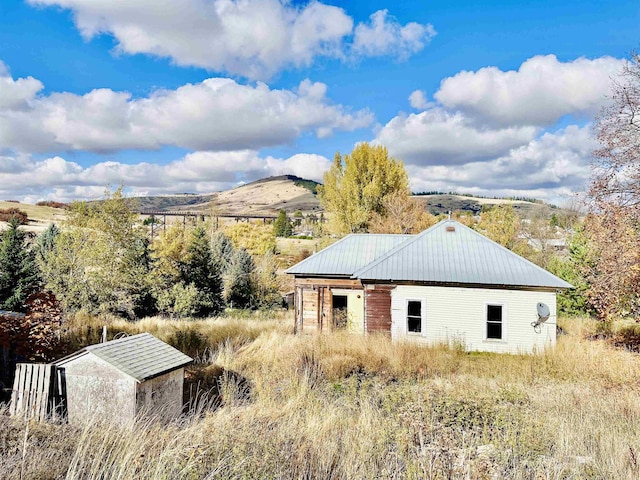 exterior space with a mountain view and metal roof