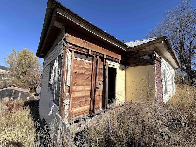 view of property exterior with metal roof