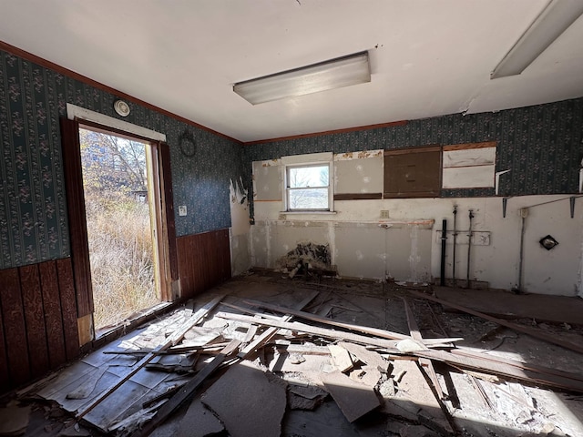 misc room featuring a wainscoted wall and wallpapered walls