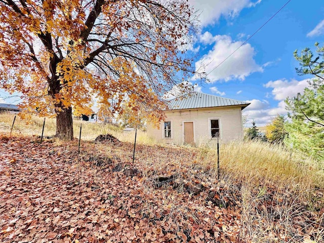 view of side of property featuring metal roof