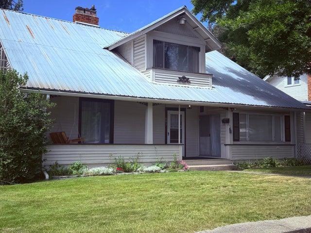 603 N Main St, Colville, WA 99114 - view of front of property featuring metal roof, a front lawn, a chimney, and covered porch