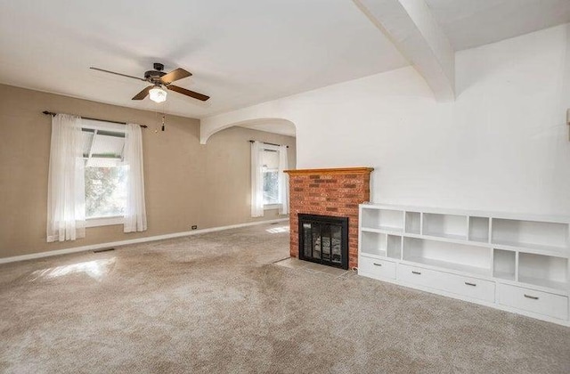 603 N Main St, Colville, WA 99114 - unfurnished living room featuring ceiling fan, healthy amount of natural light, a fireplace, and carpet