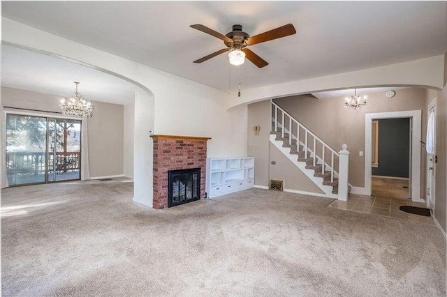 603 N Main St, Colville, WA 99114 - unfurnished living room with a chandelier, carpet floors, stairs, a brick fireplace, and baseboards