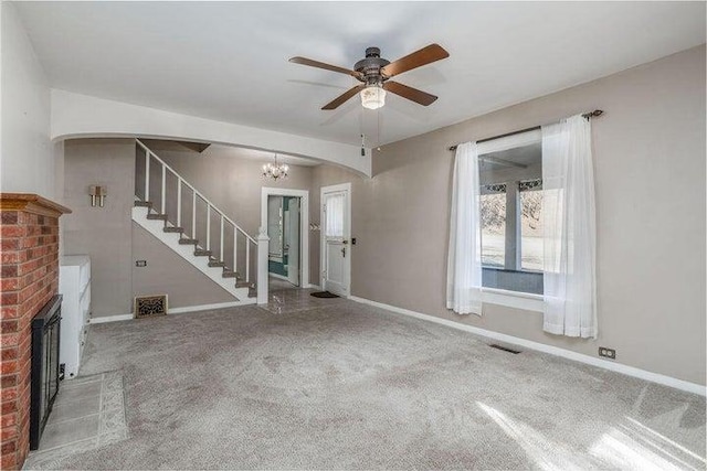 603 N Main St, Colville, WA 99114 - unfurnished living room featuring stairway, carpet floors, arched walkways, and baseboards