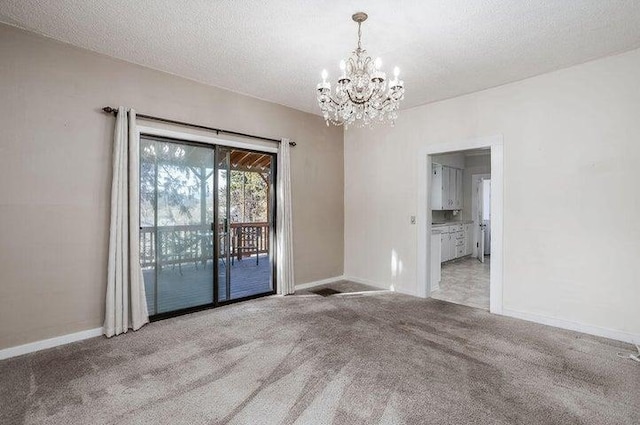 603 N Main St, Colville, WA 99114 - carpeted empty room featuring a chandelier, baseboards, and a textured ceiling