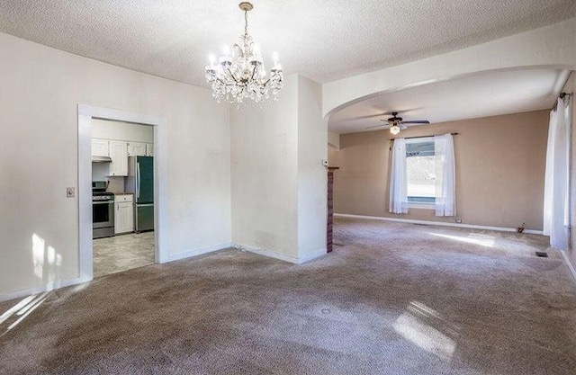 603 N Main St, Colville, WA 99114 - spare room featuring arched walkways, light carpet, a chandelier, baseboards, and a textured ceiling