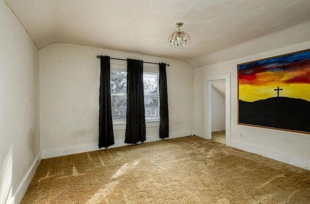 603 N Main St, Colville, WA 99114 - spare room featuring lofted ceiling, carpet flooring, a chandelier, and baseboards