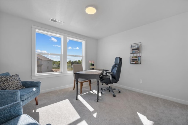 office space with carpet flooring, visible vents, and baseboards