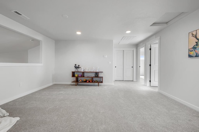 spare room with recessed lighting, visible vents, attic access, carpet flooring, and baseboards