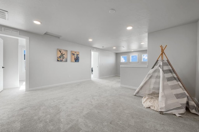 recreation room with baseboards, visible vents, light colored carpet, and recessed lighting