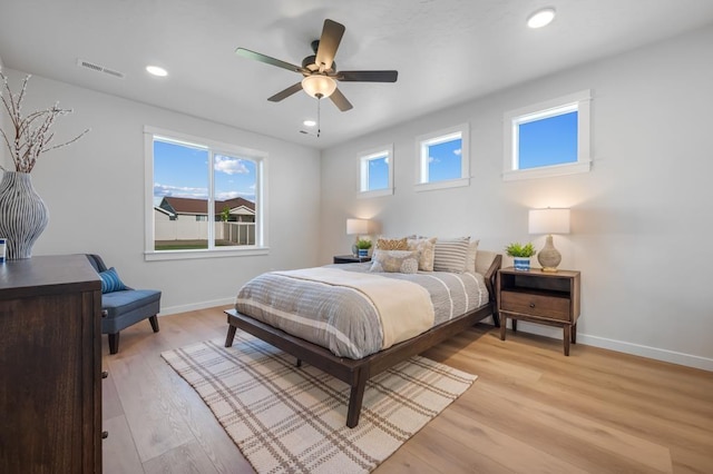 bedroom with recessed lighting, light wood-type flooring, visible vents, and baseboards