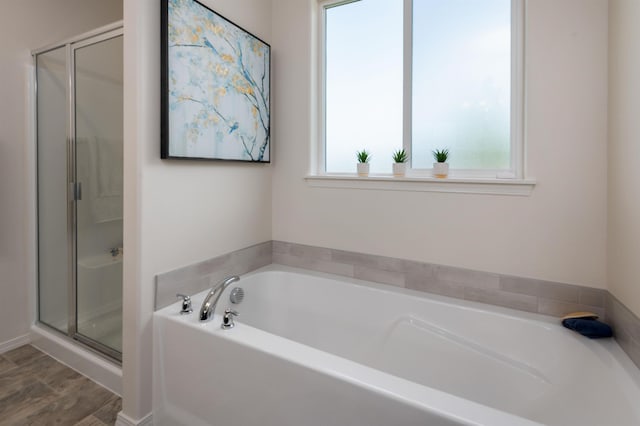 bathroom featuring a stall shower and a garden tub