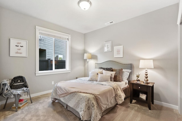 bedroom featuring carpet floors, visible vents, and baseboards