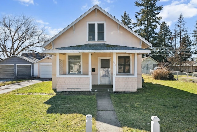 bungalow-style house with roof with shingles, covered porch, fence, an outdoor structure, and a front lawn