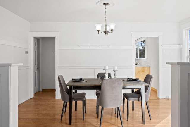 dining space featuring a chandelier and light wood-style flooring