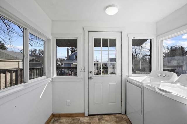 unfurnished sunroom featuring separate washer and dryer