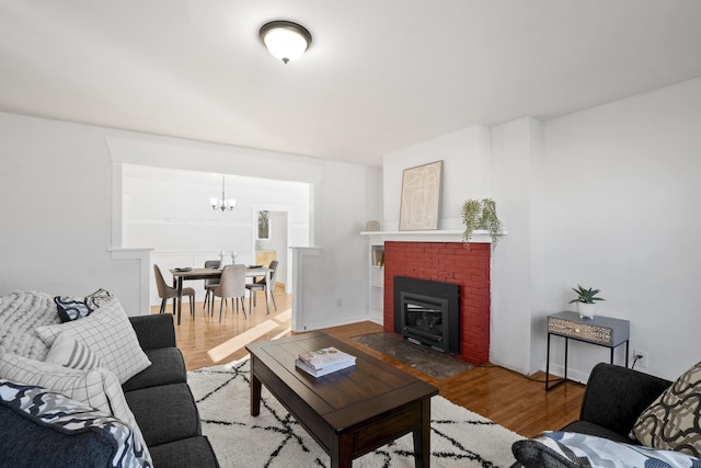 living area with a chandelier and wood finished floors