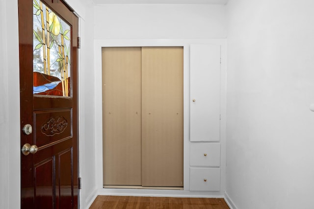 interior space featuring baseboards and wood finished floors