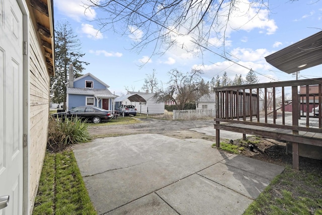 view of patio with fence and driveway