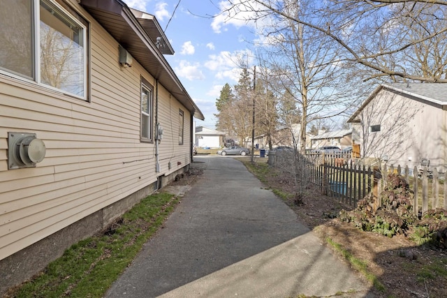 view of side of property featuring fence