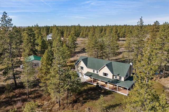 birds eye view of property with a forest view