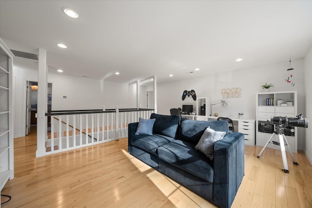 living area featuring light wood-style flooring and recessed lighting