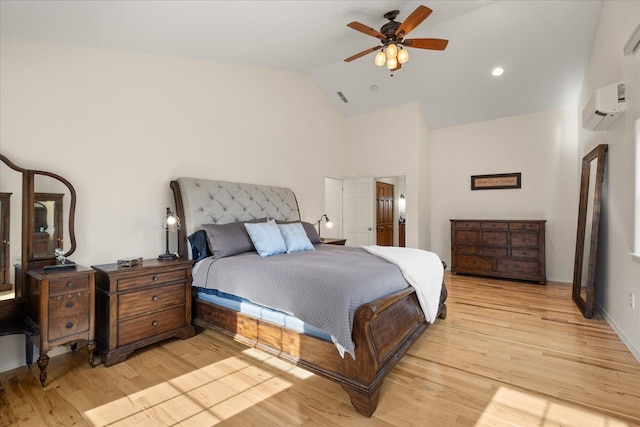 bedroom with visible vents, light wood-style flooring, ceiling fan, an AC wall unit, and high vaulted ceiling